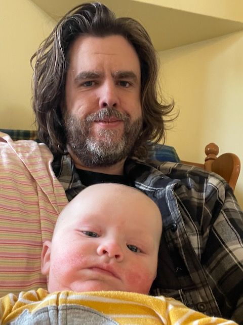 Baby and his dad in a rocking chair