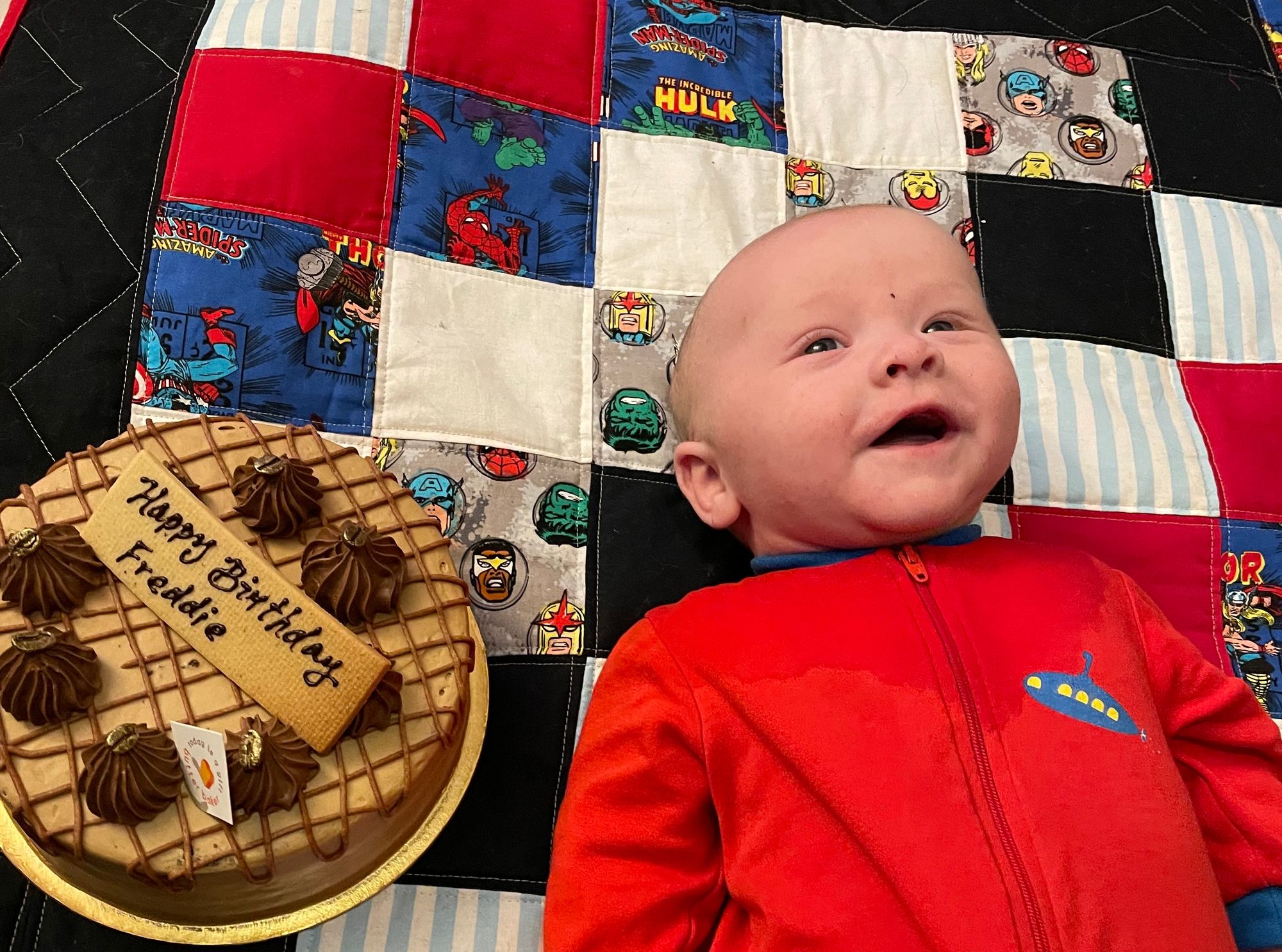 Freddie, with an awed look on his face, is again next to a cake