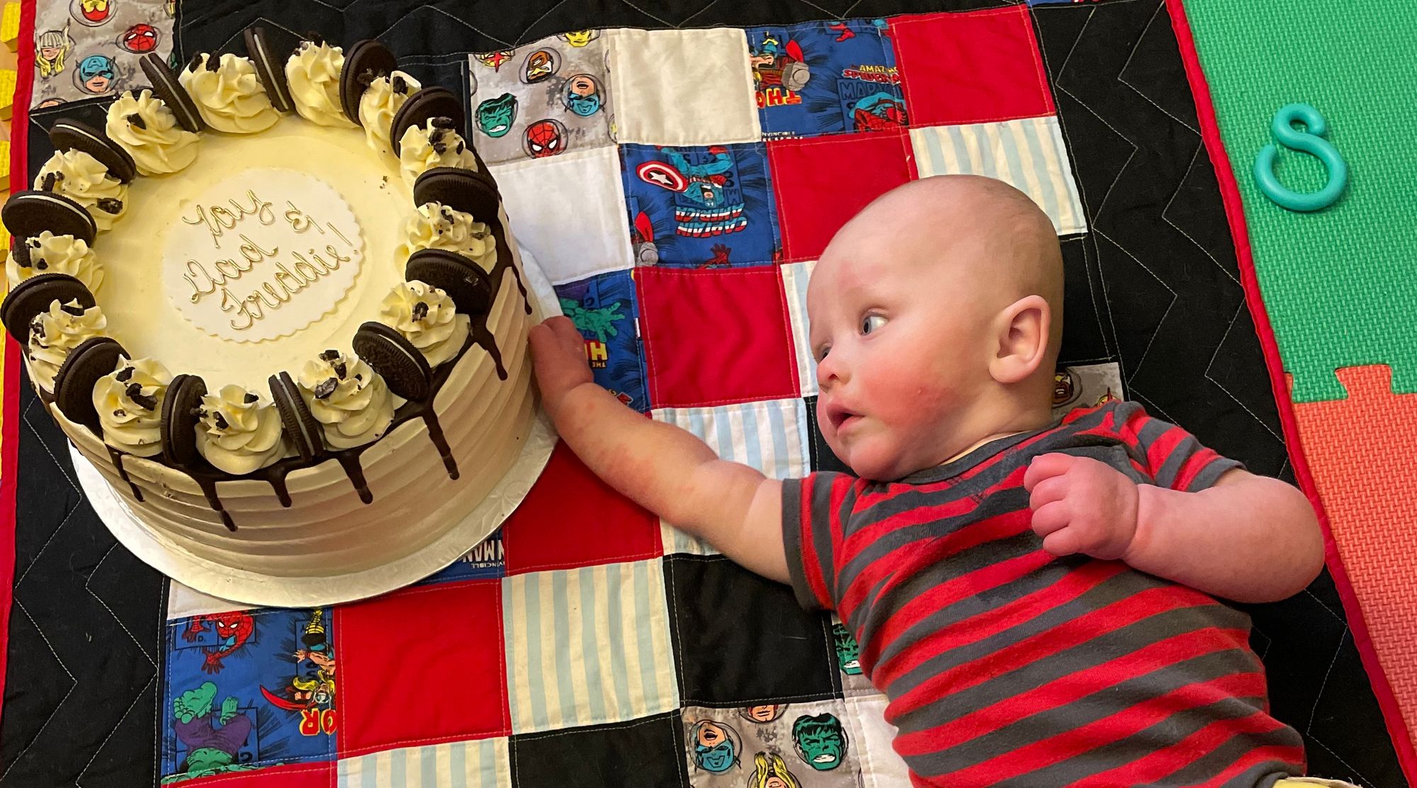 Freddie reaches for a giant cake in a red shirt