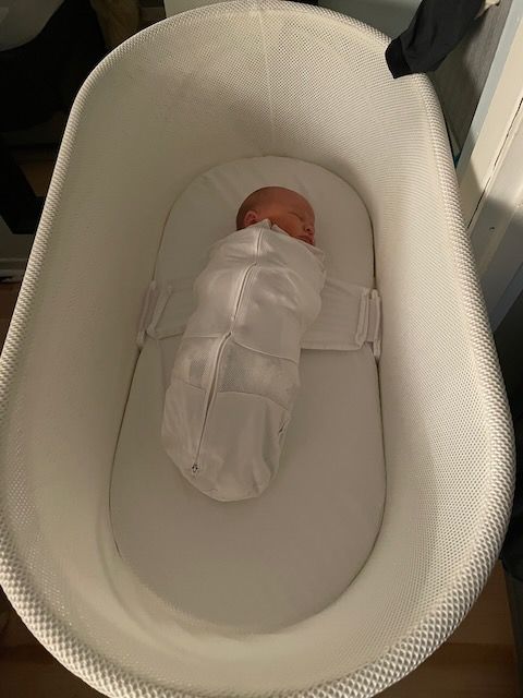Baby sleeping in a Snoo smart bassinet